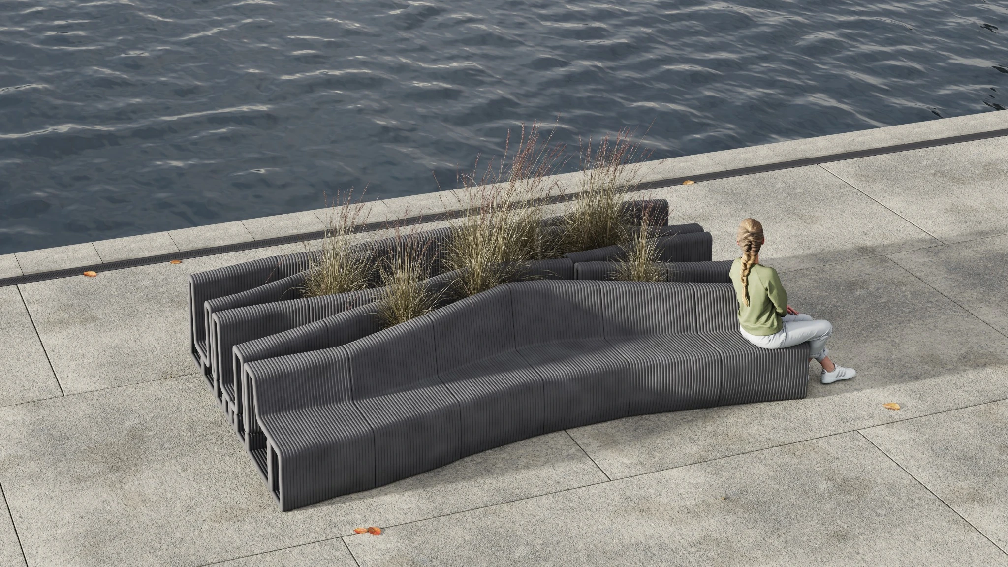 The bench beside a waterfront, with planting in the fissures and a person seated at one end.
